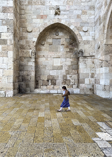 The Jaffa Gate with a girl walking through it