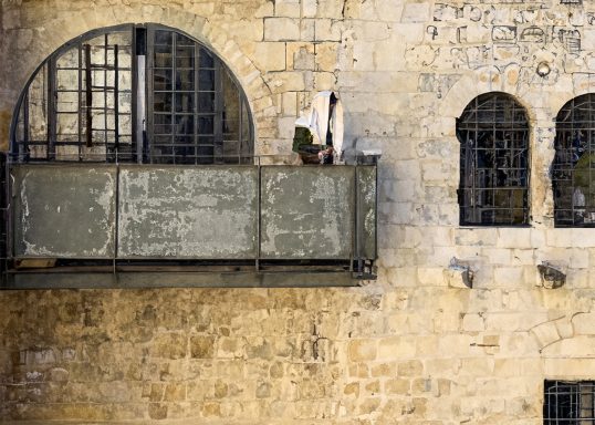 Photo watercolor of a person standing on a weathered balcony